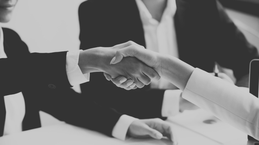Handshake in a work setting in black and white